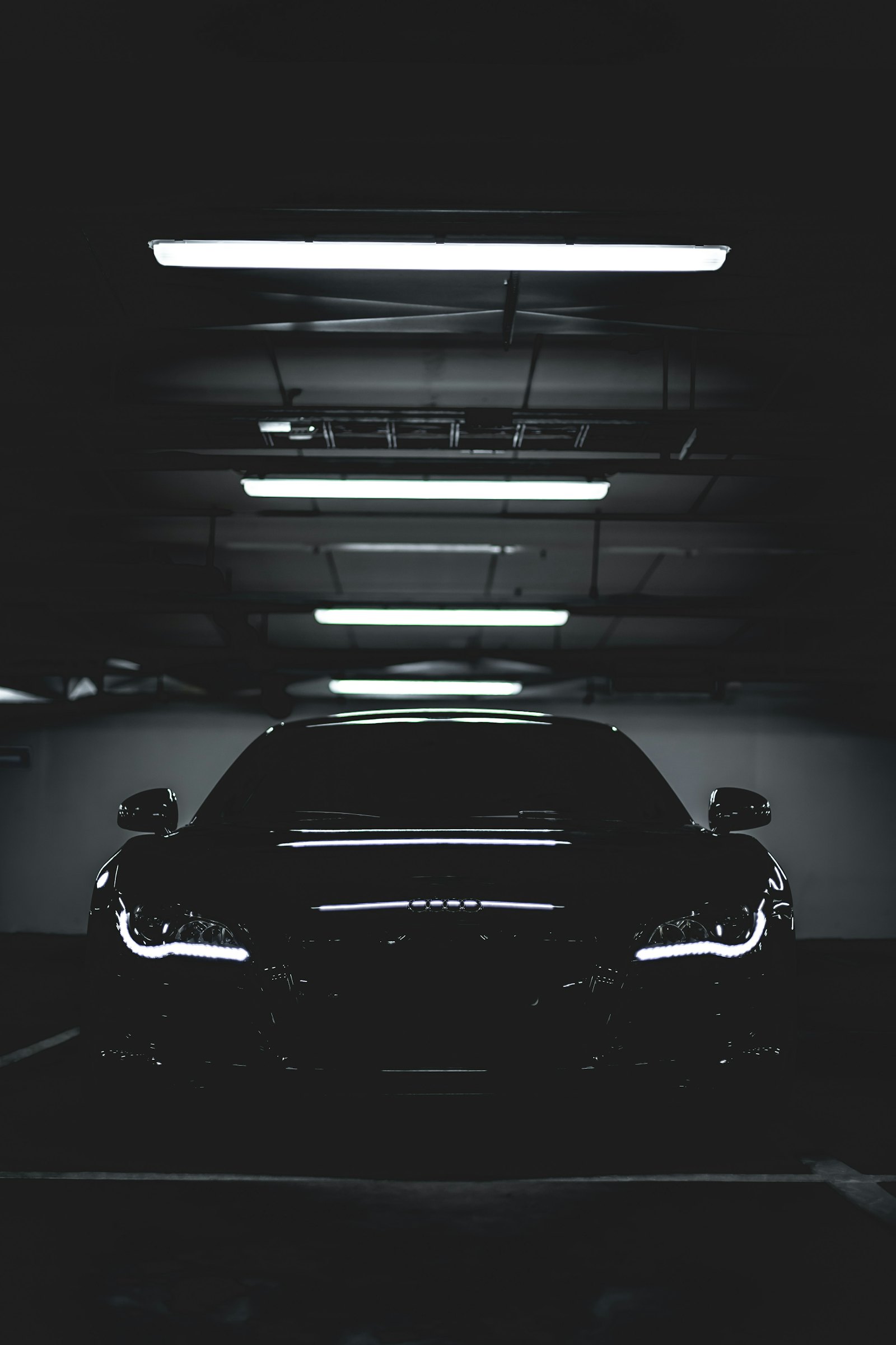 Black car under studio lights